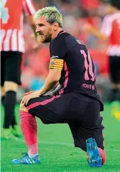  ?? — AFP ?? Argentina forward Lionel Messi looks on with a kneel on the ground during the Spanish league match for Barcelona against Athletic Club Bilbao at the San Mames stadium in Bilbao on Sunday.