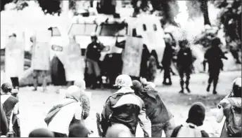  ??  ?? Demonstrat­ors clash with riot security forces while rallying against Venezuela’s President Nicolas Maduro’s government in Caracas.