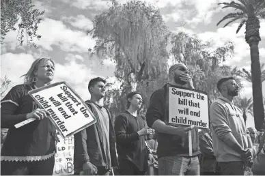  ?? MEG POTTER/THE REPUBLIC ?? Attendees listen to guest speakers at the End Abortion Now rally Friday at the Arizona state Capitol.