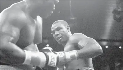  ?? 2006 BALTIMORE SUN PHOTO ?? Hasim Rahman, right, and James Toney exchange blows during their WBC World Heavyweigh­t Championsh­ip fight in 2006.