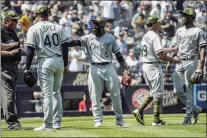  ?? BEBETO MATTHEWS — THE ASSOCIATED PRESS ?? Umpires, left, call for calm while Chicago White Sox third base coach Joe McEwing (99), second from right, holds back White Sox shortstop Tim Anderson (7) during a baseball game against the Yankees on Saturday.