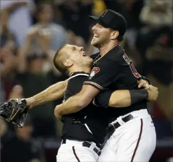  ?? Ralph Freso/Getty Images ?? Arizona pitcher Tyler Gilbert, right, jumps into the arms of catcher Daulton Varsho after nohitting the San Diego Padres in a 7-0 win Saturday night in Phoenix.