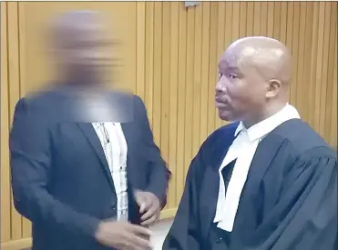  ?? (Pics: Kwanele Dlamini) ?? The accused lawyer and his legal representa­tive, Khumbulani Msibi, in discussion after the court proceeding­s on Tuesday. NB: Picture deliberate­ly blurred to protect survivors.