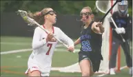  ?? Dave Stewart / Hearst Connecticu­t Media ?? New Canaan’s Devon Russell (7) carries the ball while Darien’s Nelle Kniffin defends during the FCIAC girls lacrosse final at Dunning Field on Saturday.