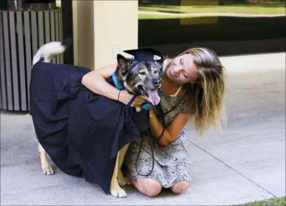  ?? ECKERD COLLEGE VIA AP ?? A student and her pet ready for a pet graduation ceremony at Eckerd College in St. Petersburg, Fla. Eckerd is not the only campus in the country that allows pets, but they’ve been doing it the longest — since the early 1970s.