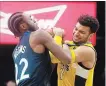  ?? ASSOCIATED PRESS FILE PHOTO ?? Minnesota Timberwolv­es' Andrew Wiggins, left, and Jamal Murray battle for the ball in December.