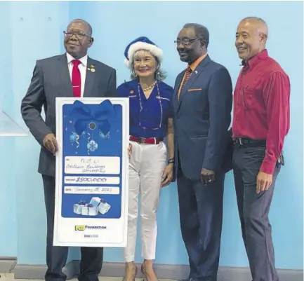  ?? (Photos: Kasey Williams) ?? (From left) NCU president Dr Lincoln Edwards, chair of the NCB Foundation Thalia Lyn, United States Ambassador to Jamaica N Nick perry and Dr Robert Chen pose for a photo op with a $500,000 cheque from the NCB Foundation. Dr Chen, son of the late Hyacinth Chen, represente­d his brother and business mogul Michael Lee-chin.