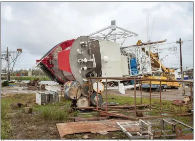  ?? (AP/The Daily Advertiser/Scott Clause) ?? A boat rests on its side Monday in Houma, La., after Hurricane Ida came ashore Sunday. The storm has disrupted offshore production and onshore refining along the Gulf Coast, but the typical drop in demand for gasoline and other fuels in September and October raises the possibilit­y that the U.S. will see a smaller effect on prices.