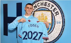  ?? Photograph: Matt McNulty/Manchester City/Manchester City FC/Getty Images ?? Phil Foden holds a Manchester City shirt showing when his new contract will end.