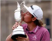  ?? AP PHOTO BY PETER MORRISON ?? Cameron Smith, of Australia, kisses the claret jug trophy as he poses for photograph­ers on the 18th green after winning the British Open golf Championsh­ip on the Old Course at St. Andrews, Scotland, Sunday July 17, 2022.