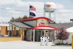  ?? AP PHOTO/MICHAEL CONROY ?? Workers leave the Tyson Foods pork processing plant in Logansport, Ind., on May 7, 2020. Tyson Foods, on Friday, entered an agreement that secured union support for its mandate that all U.S. employees get vaccinated against the COVID-19 virus.