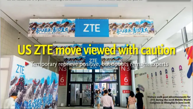  ?? Photo: IC ?? Visitors walk past advertisem­ents for ZTE during the 2018 Mobile World Congress in Shanghai in June 2018.