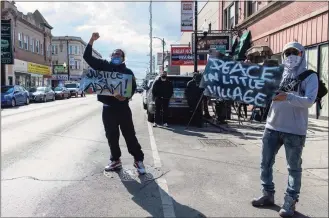  ?? Tyler LaRiviere / Associated Press ?? Enrique Enriquez, left, and a community activist rally on 26th St. after the body camera footage of Chicago police killing Adam Toledo was released on Thursday.