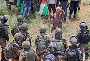  ?? AFP ?? PROTEST AGAINST SETTLEMENT: A Palestinia­n protester confronts Israeli forces during a demonstrat­ion against Israeli settlement­s in Al Sawiya village in the occupied West Bank. —