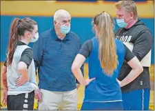  ?? SEAN D. ELLIOT/THE DAY ?? Bacon Academy girls’ basketball head coach John Shea, right, and coach emeritus Dave Shea work with junior Valerie Luizzi, left and sophomore Marissa Nudd, right, as the team practices for the first time on Tuesday in Colchester.