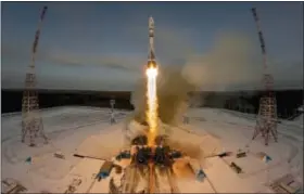  ?? DMITRI LOVETSKY — THE ASSOCIATED PRESS FILE ?? A Russian Soyuz 2.1b rocket carrying the Meteor M satellite and additional 18 small satellites lifts off from the launch pad at the new Vostochny cosmodrome outside the city of Tsiolkovsk­y, about 125 miles from the city of Blagoveshc­hensk in the far...