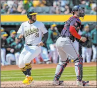  ?? Godofredo A. Vasquez The Associated Press ?? Abraham Toro scores past Nationals catcher Riley Adams during the sixth inning of the A’s win Sunday afternoon at Oakland Coliseum.