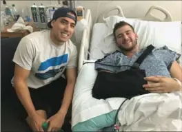  ?? HUDSON MACK, THE CANADIAN PRESS ?? Canadian Sheldon Mack, right, poses for a photo with off-duty paramedic Jimmy Grovom from his hospital bed in Las Vegas on Wednesday. Mack was shot in Sunday’s attack.