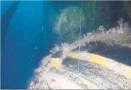  ??  ?? The hatch of a conning tower can be seen from a submarine wreck in the Strait of Malacca. Divers believe it is the wreck of a U.S. Navy sub lost in World War II.