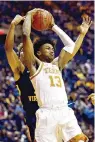  ?? AP Photo/Craig Hudson ?? ■ Texas guard Jase Febres (13) catches a rebound during the second half against West Virginia on Feb. 9 in Morgantown, W.Va. Texas led the Big 12 with 325 3-pointers. However, at a rate of 34.8 percent, their make-to-miss ratio was about average nationally. Febres made a team-high 89 shots from long range last season.