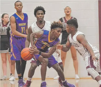  ?? | WORSOM ROBINSON/ FOR THE SUN- TIMES ?? Zion- Benton clamps down onWaukegan’s Ja’Dyn Brown, but the Bulldogs pulled out the victory.