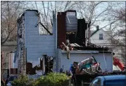  ?? MATT ROURKE — THE ASSOCIATED PRESS ?? Authoritie­s were searching the charred remains of a suburban Philadelph­ia home Thursday morning, a day after a shootout and fire left two police officers wounded and at least six people unaccounte­d for.