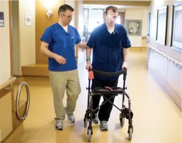  ?? CARLOS OSORIO/TORONTO STAR ?? Practical nurse Michael Carlin, a Nightingal­e nominee, helps patient Neil Bailey at the Toronto Rehab Centre.