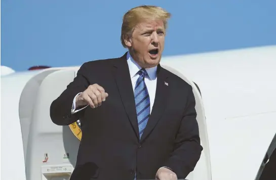  ?? AP PHOTO ?? LET’S TALK: President Trump calls out as he arrives on Air Force One at Morristown Municipal Airport, in Morristown, N.J., Friday en route to Trump National Golf Club in Bedminster, N.J.