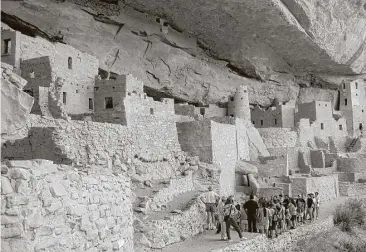  ?? Beth J. Harpaz / Associated Press ?? Visitors tour Cliff Palace, an ancient cliff dwelling in Mesa Verde National Park, Colo. New evidence may help solve the mystery of what happened to the Ancestral Puebloans who lived there.