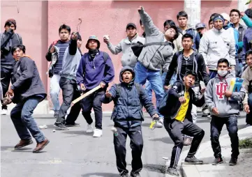  ??  ?? Coca growers from Yungas clash with riot policemen in La Paz, Bolivia. — Reuters photo