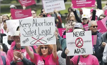  ?? Rich Pedroncell­i Associated Press ?? STATE LAWMAKERS last week sent Gov. Gavin Newsom the last of 15 bills aimed at strengthen­ing California’s already robust abortion protection­s. Above, abortion rights supporters rally in Sacramento in 2019.