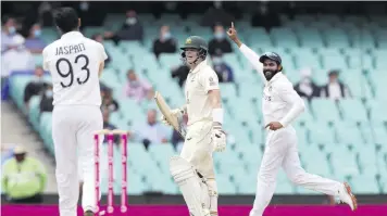  ?? (Photo: AFP) ?? India’s Ravindra Jadeja (right) celebrates after running out Australia’s Steven Smith (centre) during the second day of the third cricket Test match at the Sydney Cricket Ground in Sydney, yesterday.