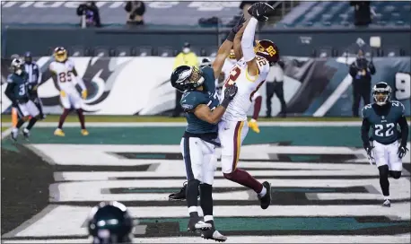  ?? CHRIS SZAGOLA – THE ASSOCIATED PRESS ?? Washington Football Team’s Logan Thomas (82) catches a touchdown pass against the Eagles’ T.J. Edwards during the first half Sunday night at Lincoln Financial Field.