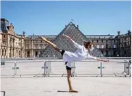  ??  ?? Syrian dancer and choreograp­her Yara Al-Hasbani performs a dance in front of the Louvre museum’s pyramid.