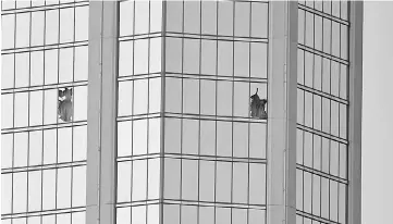  ?? — AFP photo ?? Broken windows are seen on the 32nd floor of the Mandalay Bay Resort and Casino after the lone gunman opened fired on the Route 91 Harvest country music festival.