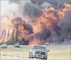  ?? CP FILE PHOTO ?? A wildfire burns through a forest south of Fort McMurray, Alta., on Highway 63 on May 7, 2016.