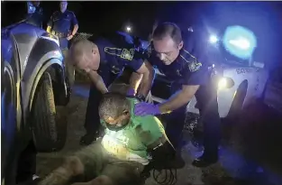  ?? LOUISIANA STATE POLICE VIA AP, FILE ?? This image from the body camera video of Louisiana State Police Trooper Dakota DeMoss shows his colleagues, Kory York, center left, and Chris Hollingswo­rth, center right, holding up Ronald Greene before paramedics arrived on May 10, 2019, outside of Monroe, La. Louisiana lawmakers investigat­ing Greene’s deadly arrest are preparing to hold Kevin Reeves, the former head of the state police, in contempt for refusing to turn over his journals after talks broke down earlier this month in a dispute over an entry mentioning Gov. John Bel Edwards.