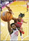  ?? ?? Chicago Bulls’ Ayo Dosunmu (right), blocks a shot by Philadelph­ia 76ers’ Paul Reed during the second half of an NBA basketball game in Philadelph­ia. (AP)