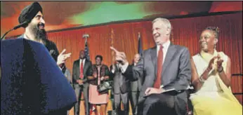  ??  ?? New York City mayor Bill de Blasio and his wife Chirlane McCray enjoy a light moment as actor and designer Waris Ahluwalia (left) speaks on the occasion of Diwali celebratio­n at the mayor’s official residence in New York on Wednesday.