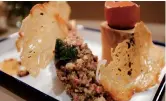  ??  ?? Australian wagyu beef tartar with egg yolk, kimchi and garlic bread crisp