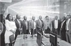  ??  ?? TelOne and National University of Science and Technology officials pose for a photo in the new research lab at the varsity campus in Bulawayo yesterday