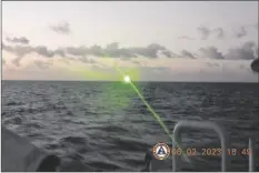  ?? PHILIPPINE COAST GUARD VIA AP ?? This photo provided by the Philippine Coast Guard shows a green military-grade laser light from a Chinese coast guard ship in the disputed South China Sea, on Feb. 6.