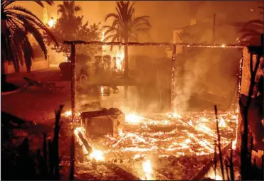  ??  ?? Destroyed: Flames reflect in a swimming pool amid the remains of a building in Javea