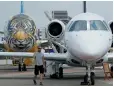  ?? — Reuters ?? An Embraer E-190 E2 aircraft featuring a spray-painted tiger face on the nose of the aircraft is displayed during a media preview of the Singapore Airshow.