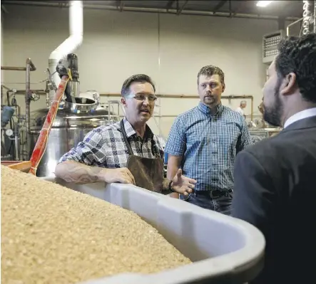  ?? IAN KUCERAK ?? Geoff Stewart, left, owner and head distiller at Rig Hand Craft Distillery in Nisku gives Culture and Tourism Minister Ricardo Miranda, right, a tour of the facility Wednesday.