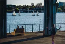  ?? RAY CHAVEZ STAFF PHOTOGRAPH­ER ?? Tanner Montierth, right, of Oakland roller skates as boats sail on the Oakland Estuary at Township Commons Park in Oakland on Thursday. Many virus restrictio­ns are still in place.