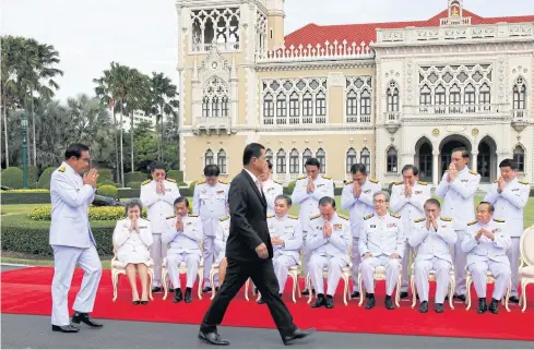  ?? THANARAK KHUNTON ?? Gen Prayut Chan-o-cha greets his cabinet ministers in front of Government House in 2015. While repeatedly criticisin­g ‘bad politician­s’, the prime minister often finds people in his own inner circle embroiled in scandals.