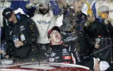  ?? JOHN RAOUX — THE ASSOCIATED PRESS ?? Harrison Burton, center, celebrates with crew members in Victory Lane after winning the ARCA series race at Daytona Internatio­nal Speedway on Saturday in Daytona Beach, Fla.