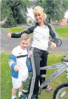  ??  ?? Stolen Chantal Gray with son Nicholas, 9, and the stolen bike