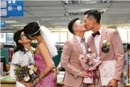  ?? Johnson Lai / Associated Press ?? Same-sex couples seal their legal marriages with kisses Friday at the household registrati­on office in the Xinyi District of Taipei, Taiwan.